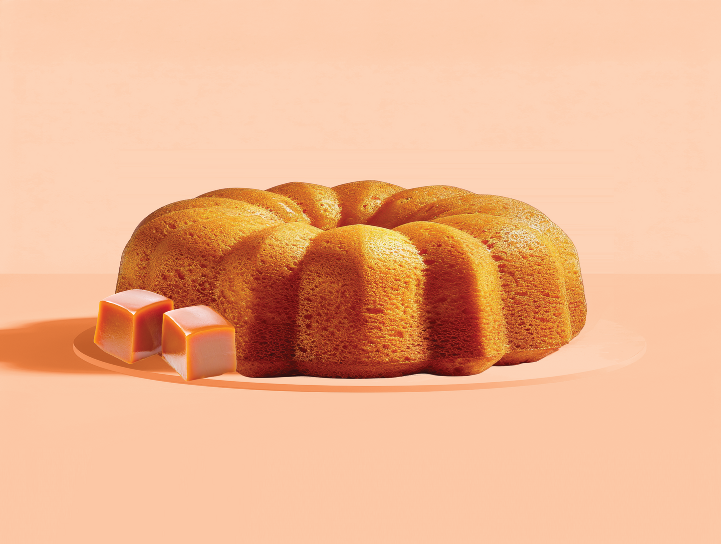 Bundt cake with caramel on a peach background